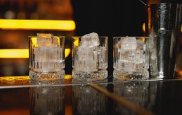 High-end bar, showcasing four crystal-clear whiskey...