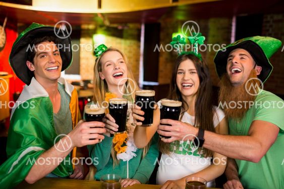 Smiling friends with Irish accessory