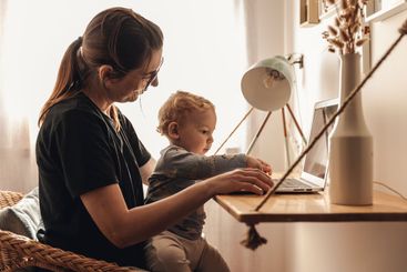 Woman working at home with her baby