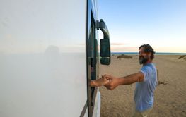 Outside view of couple holding hands. Woman inside a...