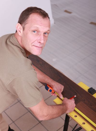 Man measuring laminate flooring