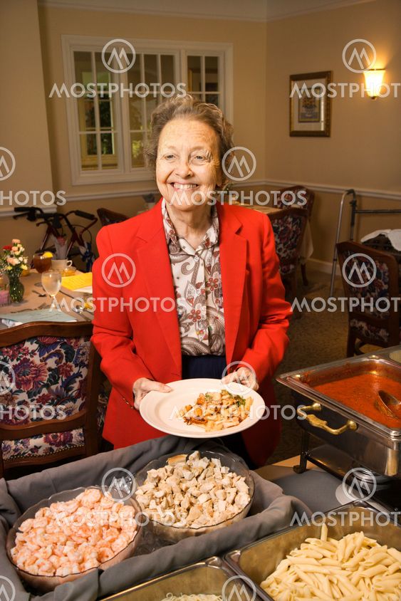 Woman at food buffet.