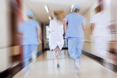 Doctor and nurse running in passageway