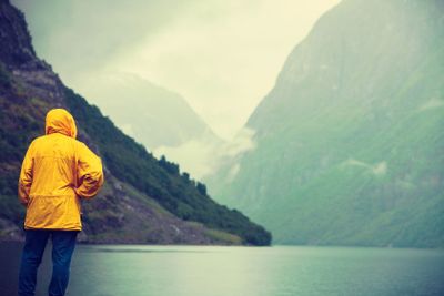 Tourist looking at mountains and fjord Norway, Scandinavia.