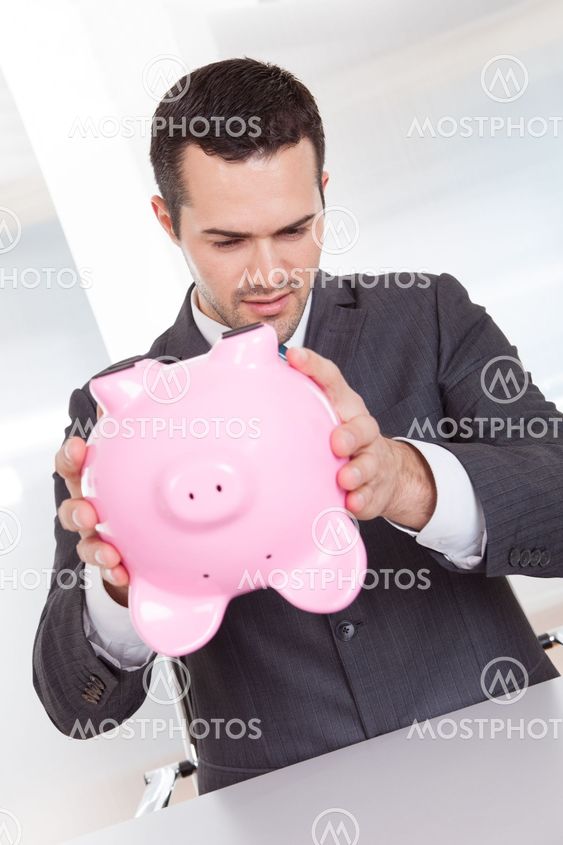 Businessman holding piggybank