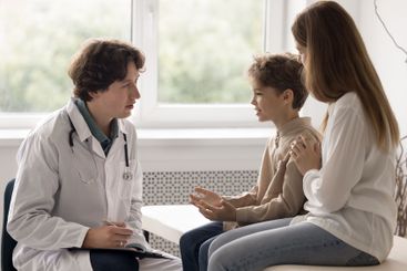 Sick little patient with mom visit young male doctor...