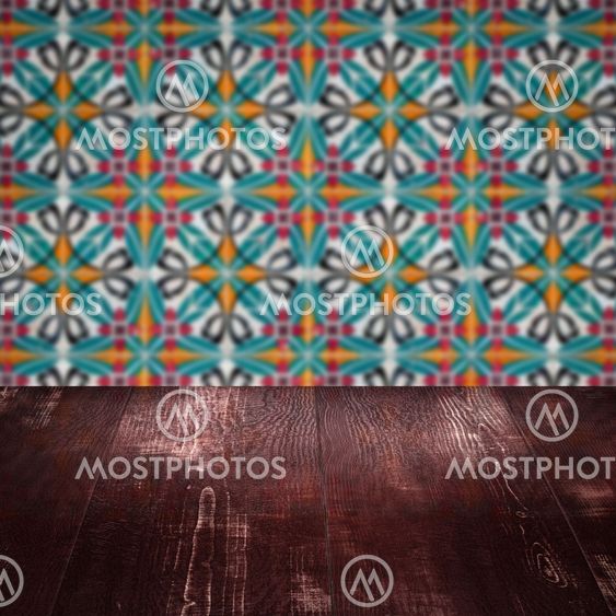 Wood table top and blur vintage ceramic tile pattern wall