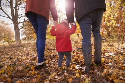 Close Up Of Young Girl On Autumn Walk With Parents