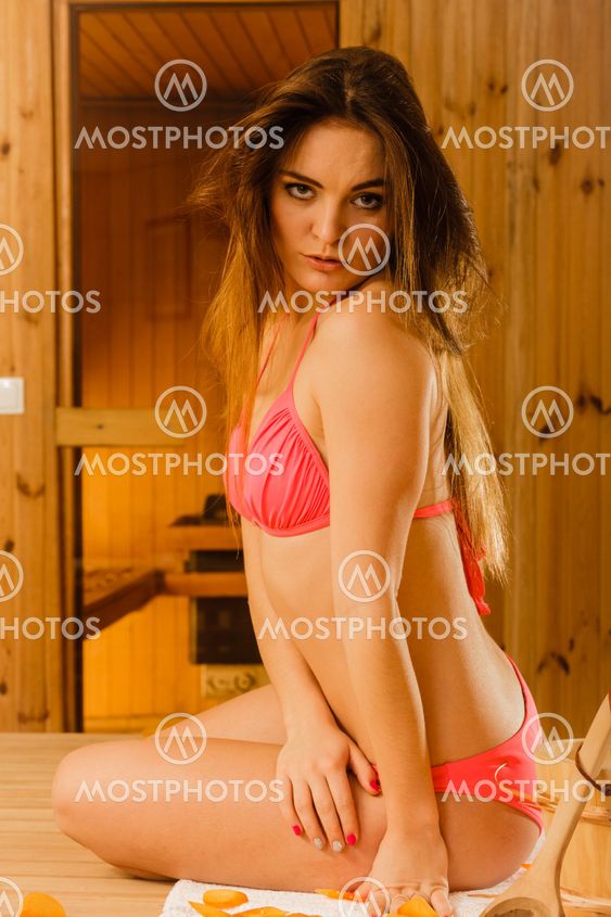 Young woman relaxing in sauna. Spa wellbeing.