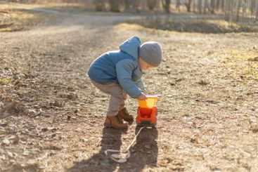 Happy baby child outdoor. Little toddler boy with toy...