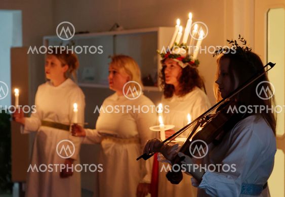 Lucia parade with singing girls and boys in white dresses...