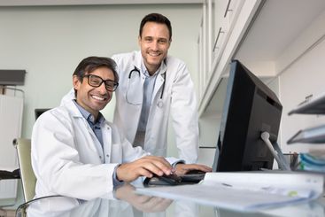 Two male doctor colleagues meeting for teamwork at...