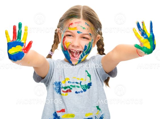 Portrait of a cute girl playing with paints