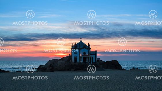 Chapel Senhor da Pedra at sunset, Miramar Beach in Porto, Portugal.