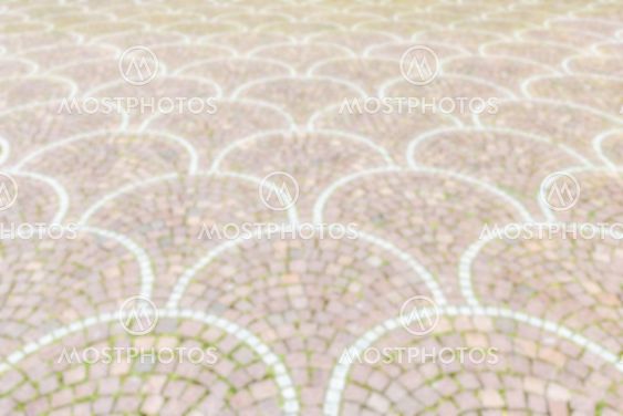 Defocused background of Sampietrini cobblestone pavement in Rome, Italy
