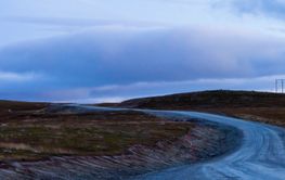 Hill and rural road under clouds