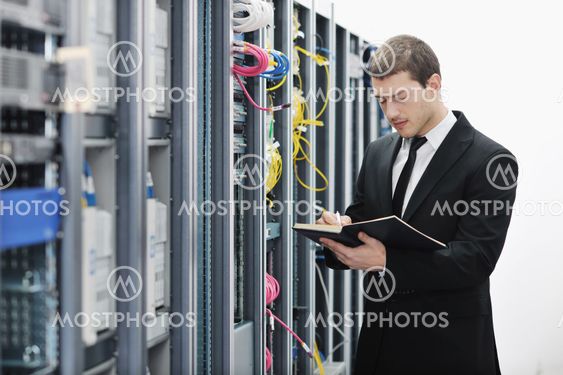 it businessman withnotebook in network server room