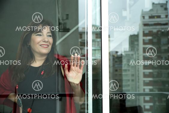 Mature woman looking out the window