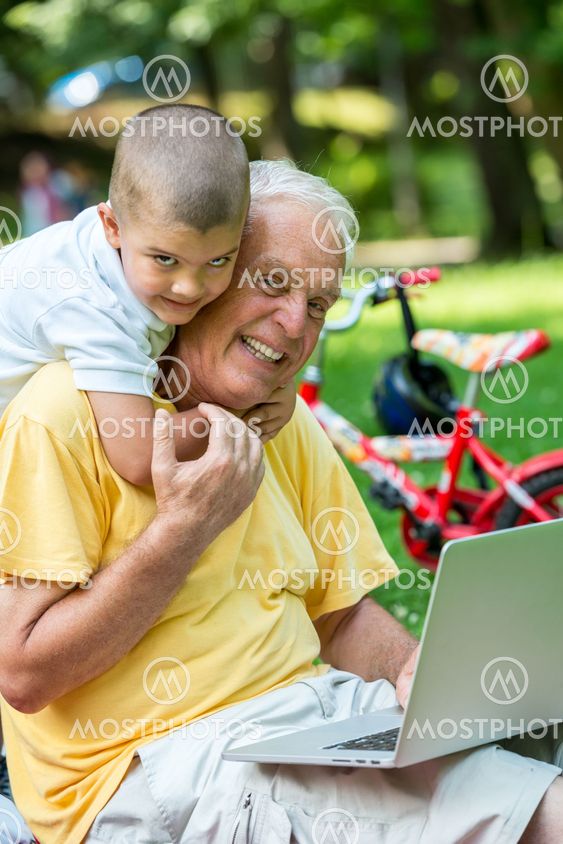 grandfather and child using laptop