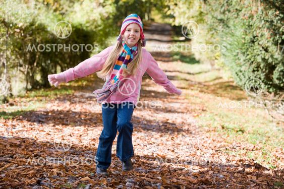 Young girl playing in woods