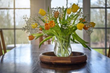 Bouquet of yellow and orange tulip flowers on a wooden...