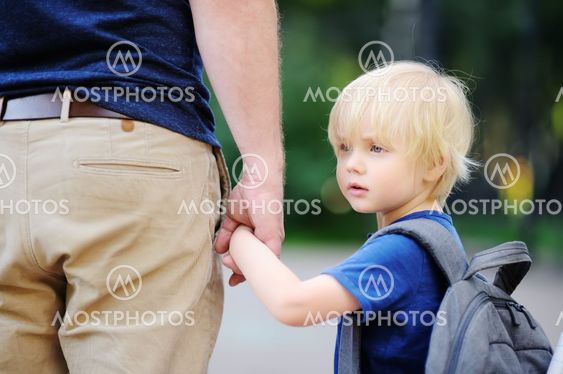 Back to school concept. Little pupil with his father....