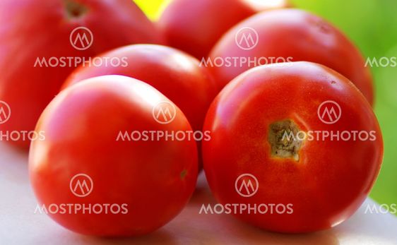 fresh red tomatoes on a white table