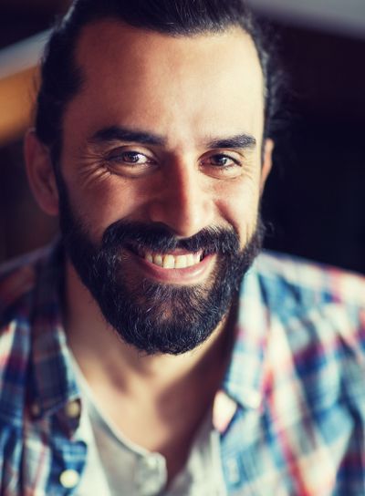 happy young man with beard and mustache