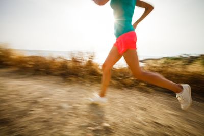 Young woman on her evening jog along the seacoast 