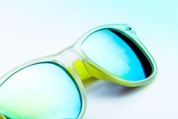 Yellow sun glasses isolated over the white background