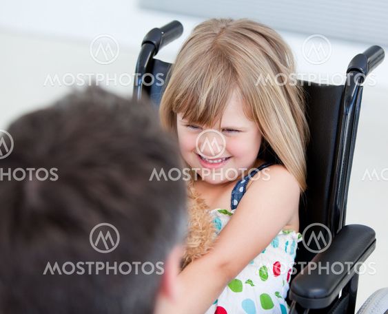 Reserved little girl sitting on the wheelchair