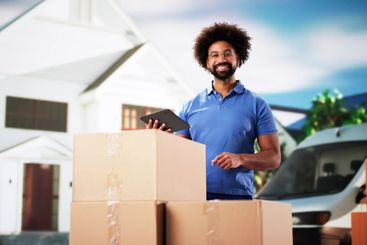 The Smiling Professional Handyman Holding a Delivery...