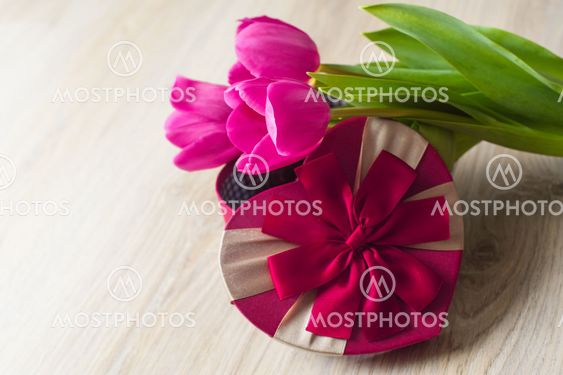 three purple tulip and a box for gift
