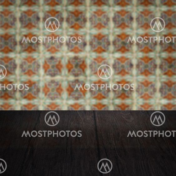 Wood table top and blur vintage ceramic tile pattern wall