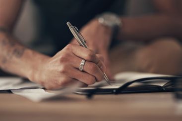 Finance, hands of man and writing notes with invoice,...