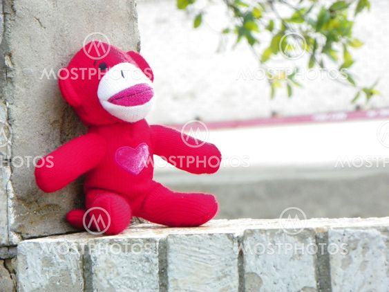 Red Monkey Sitting on Wall