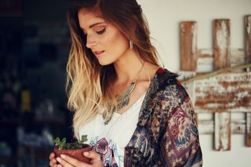 Woman, pot plant and spring in backyard for growth,...
