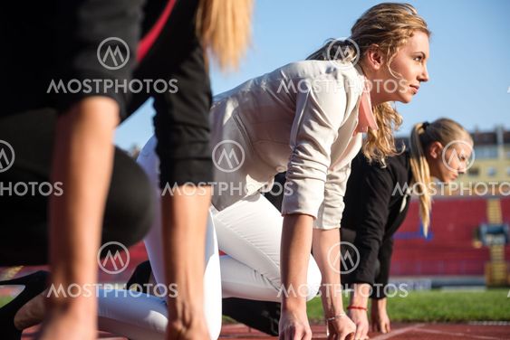 business people running on racing track