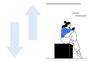 Young person sitting on a block using a mobile device...