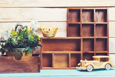 Cozy pastel wooden home decor objects on blue background