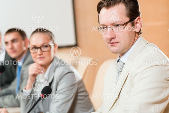 businessmen communicate at the conference