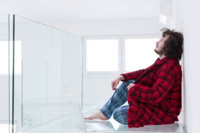 young freelancer in bathrobe working from home