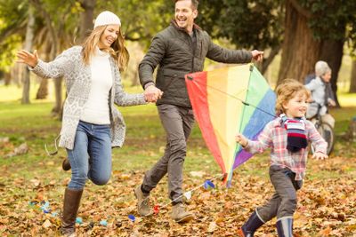 Young family playing with a kite