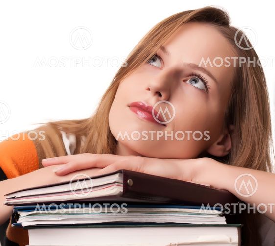 Young girl student with pile of books dreaming