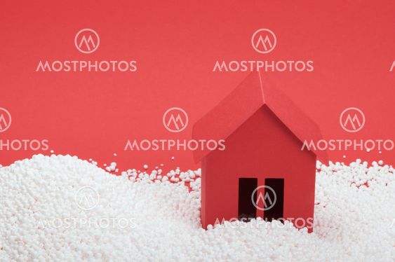 paper house in snow on red background