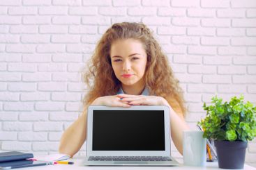 Beautiful caucasian woman sitting and working on laptop