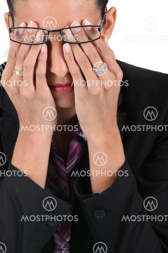 Woman in glasses rubbing her eyes