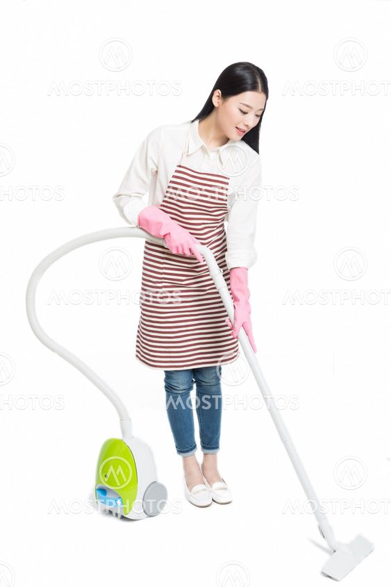 chinese young woman with a vacuum cleaner