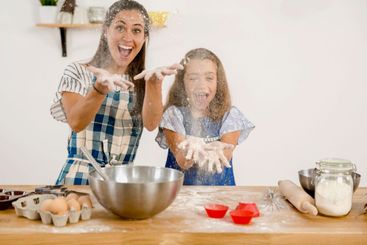 Mother and daughter making a cake