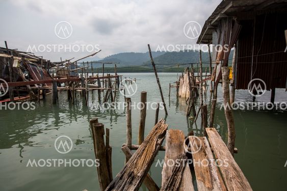 Broken abandoned pier of wooden planks in the Thai...